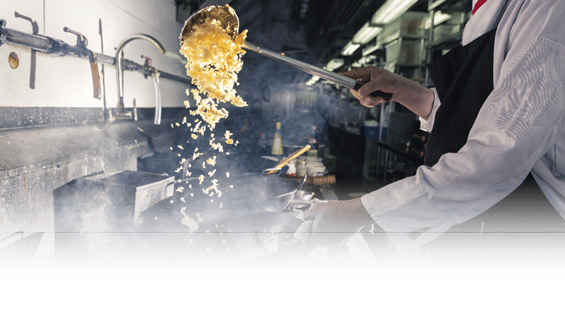 Chef is stirring vegetable in wok