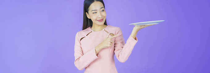 Portrait beautiful young asian woman smile with empty plate dish on color background