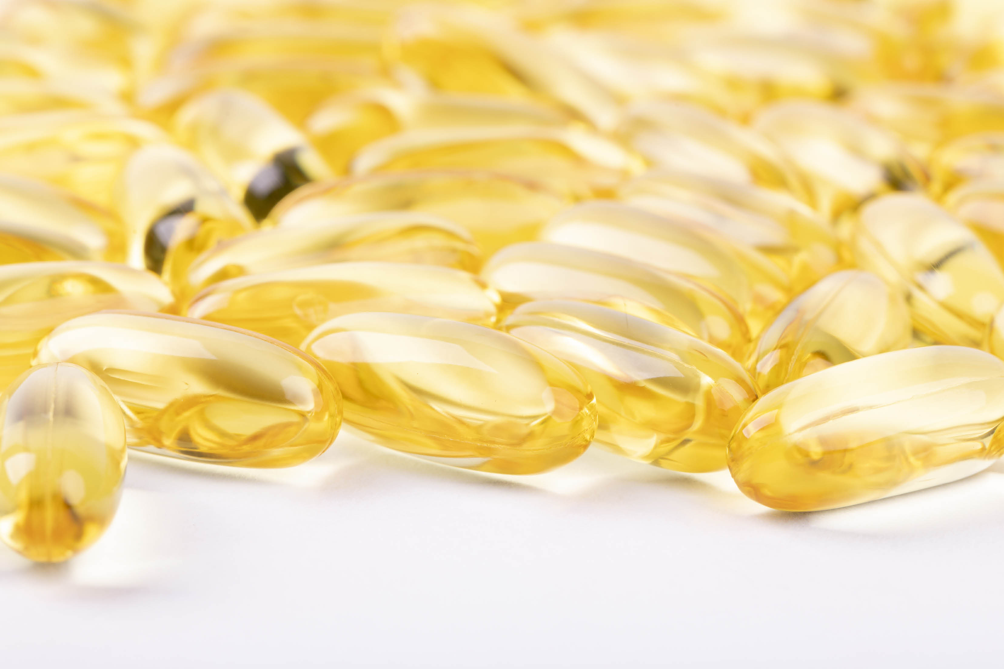 A closeup shot of fish oil capsules isolated on white background